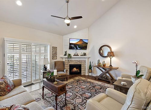 a living room filled with furniture and a fire place