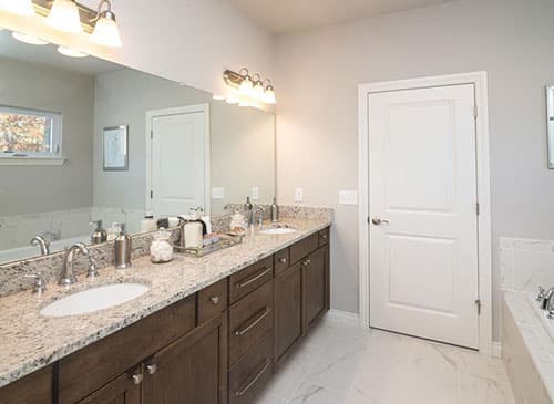 a kitchen with a sink and a mirror