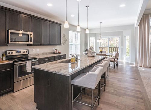 a modern kitchen with stainless steel appliances and wooden cabinets