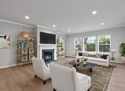 a living room filled with furniture and a large window