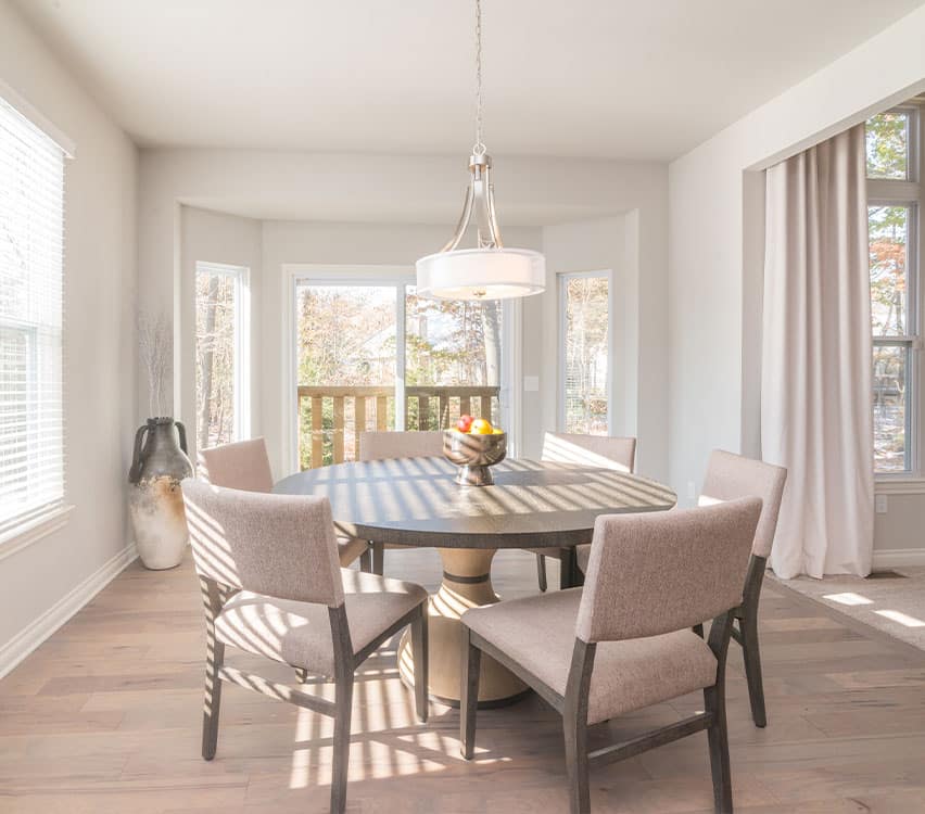 a dining room table in front of a window