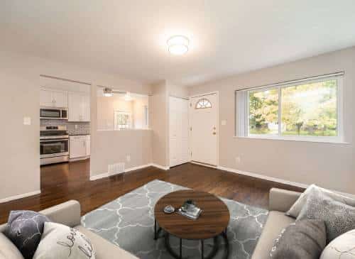 a living room filled with furniture and a large window