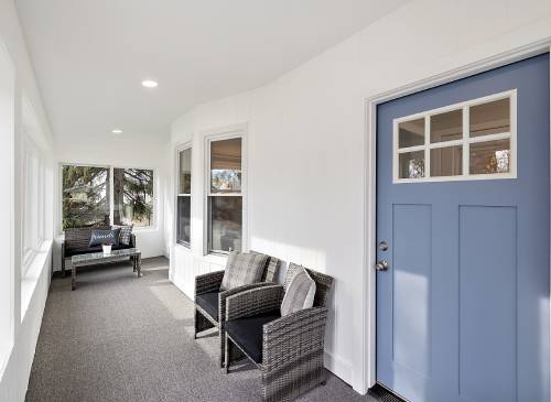 a room filled with furniture and a large window