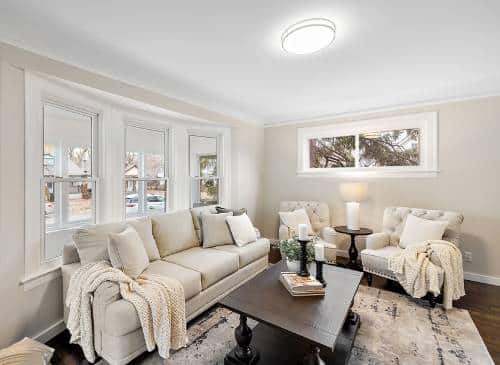 a living room filled with furniture and a large window