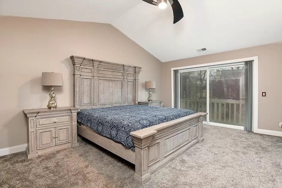 a bedroom with a bed and a mirror in a room