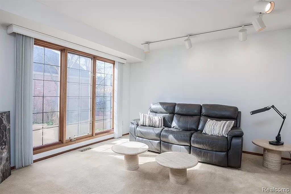 a living room filled with furniture and a large window